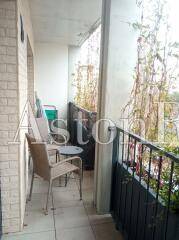 Balcony of a 2-room apartment with metal railings and outdoor seating.