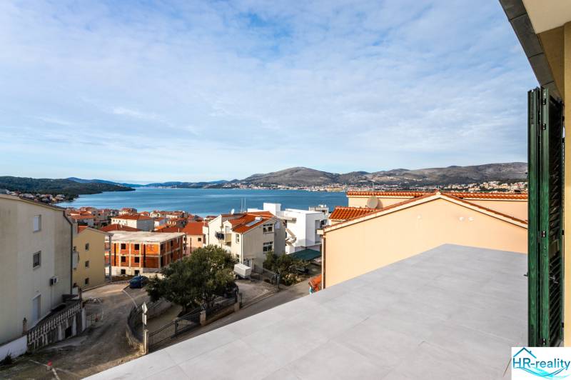 View from the terrace of a 3-room apartment in the city of Trogir to the sea and surrounding rooftops.