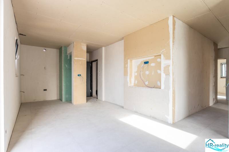 An anticipated 3-room apartment with unfinished walls and a light floor with a wooden decor.