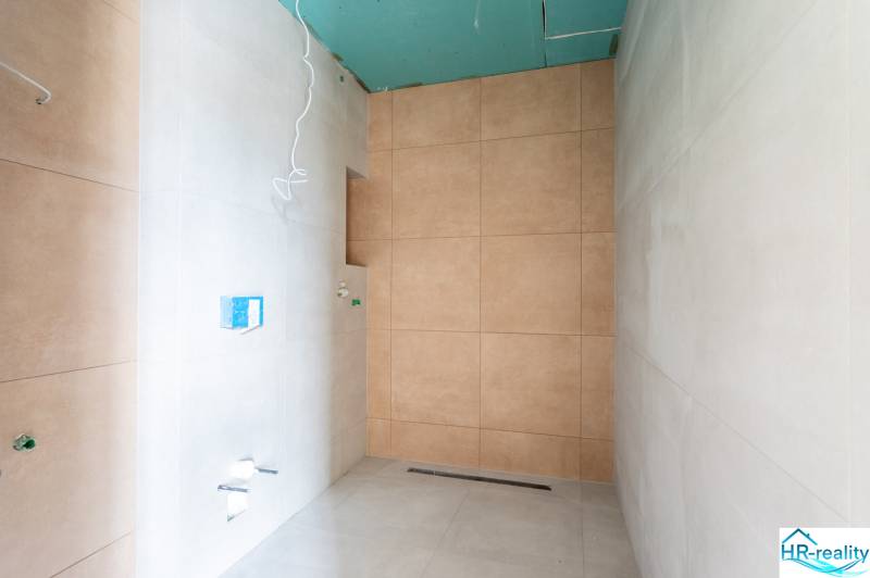 A bathroom in a 3-room apartment with tiles in neutral colors, ready for completion.
