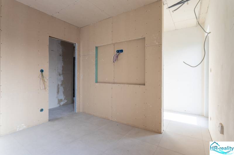 Interior of a 3-room apartment with unfinished walls and flooring.