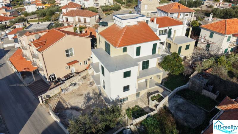 A construction project in Trogir with red roofs and surrounding family houses.