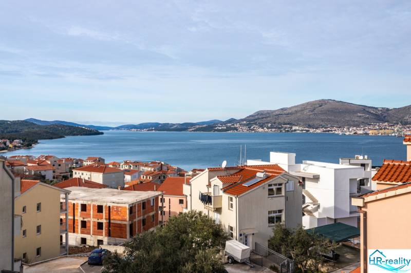 View of Trogir with the coastline and rooftops of houses, ideal for a 3-bedroom apartment.