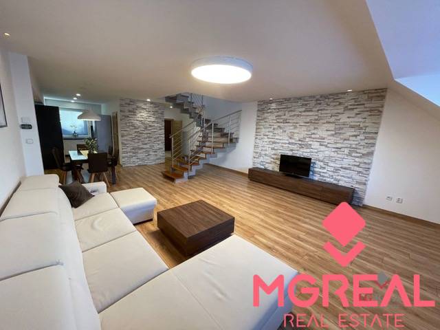 Living room in a 3-room apartment with a wooden decor floor and comfortable seating.