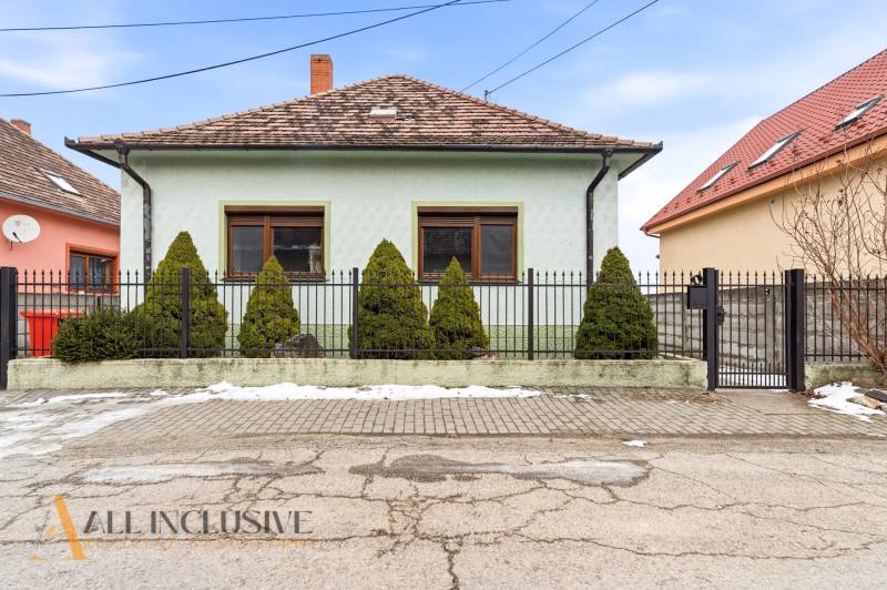 A family house on Čečínska Potôň in Orechová Potôň with a fence and a garden.