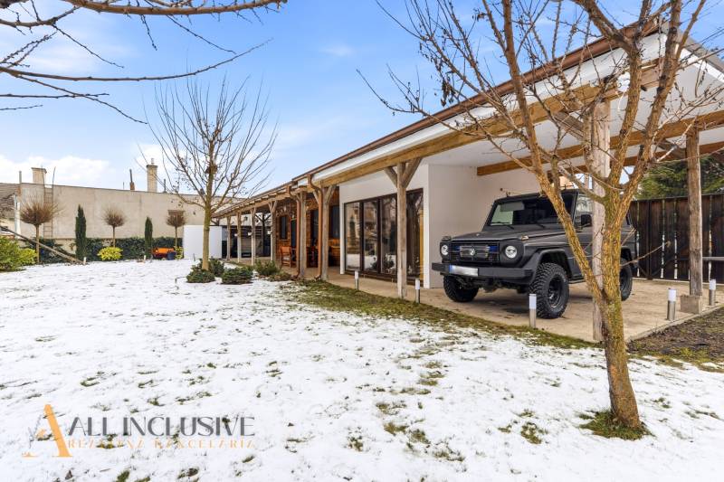 Exterior of a family house in Dolný Štál with a terrace and a car on a snowy plot.