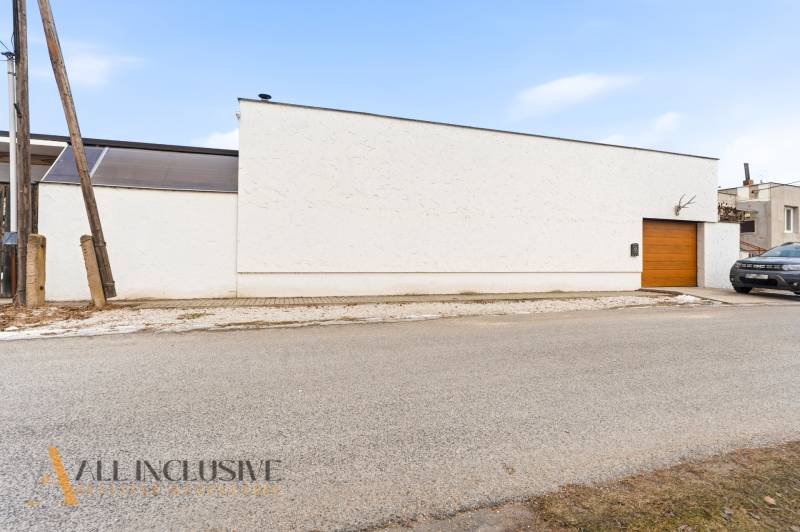A family house in Dolný Štál with a modern facade and a wooden garage door.