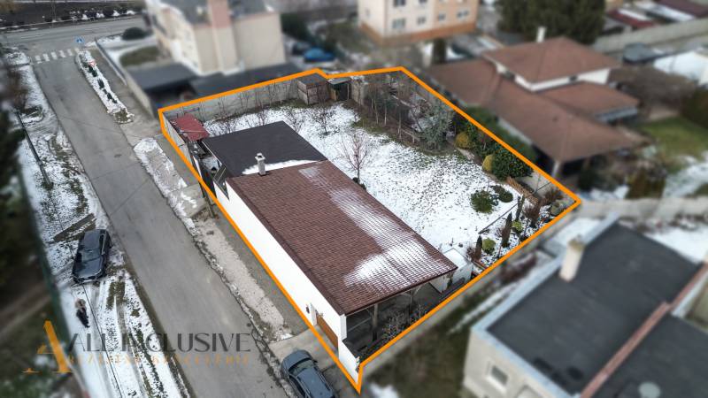 A family house in Dolný Štál with a fenced plot, winter atmosphere, snow-covered garden.