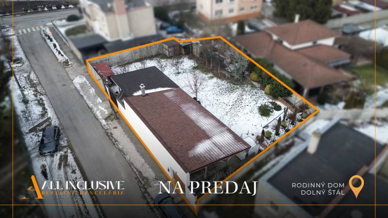 A family house in Dolný Štál for sale, a snow-covered garden bordered by an orange line.