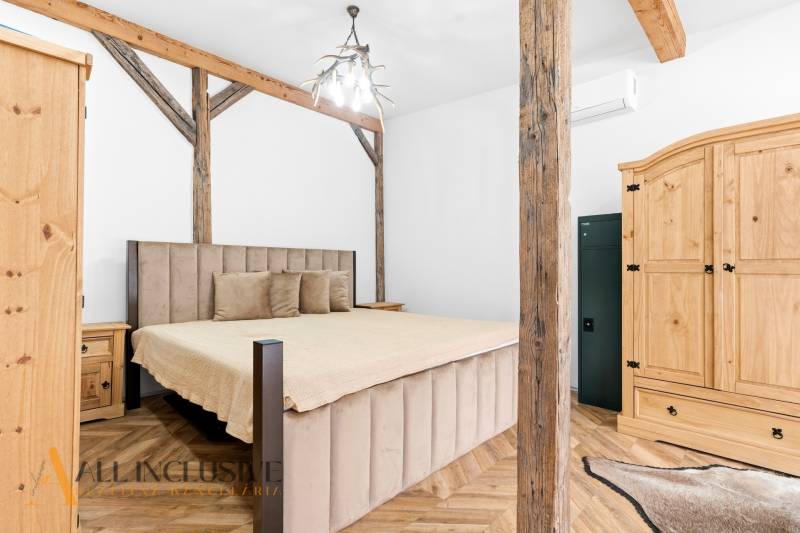 A bedroom in a family house with wooden decor and rustic elements.