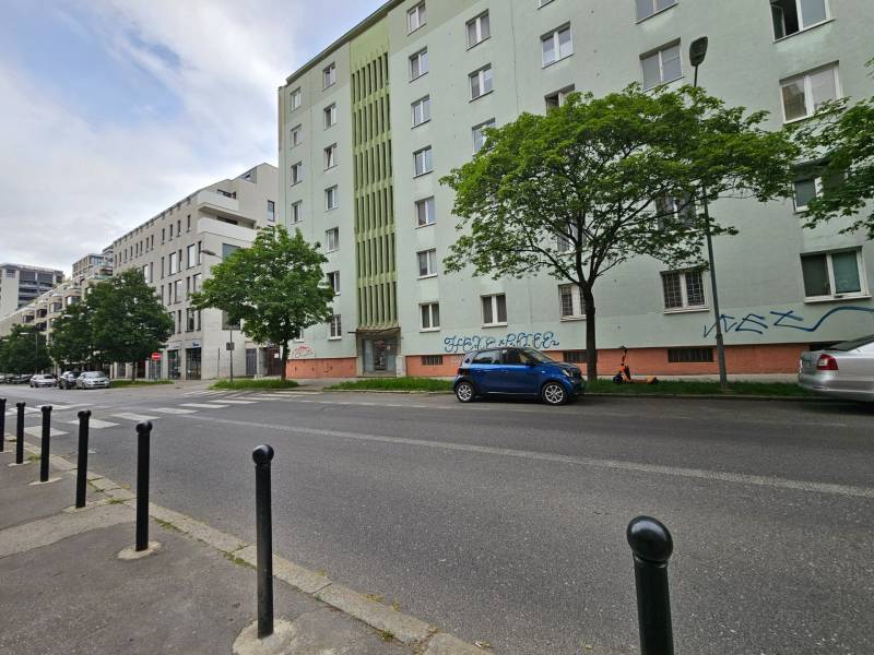 Mýtna Street, Bratislava - Staré Mesto, shows a row of apartment buildings and parked cars.