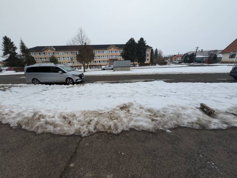 Snow cover, Remeselnícka Street in Ľubica, a minivan is parked on the road in front of a building.