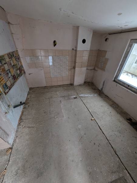 Empty room with tiled walls in a family house.