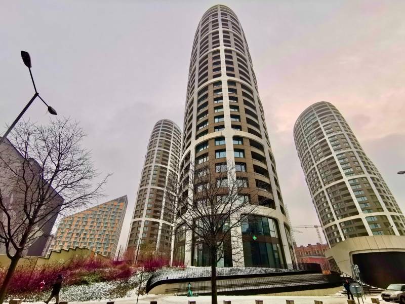 High-rise buildings on Bottova Street in Bratislava - Old Town, snowy surroundings and trees.