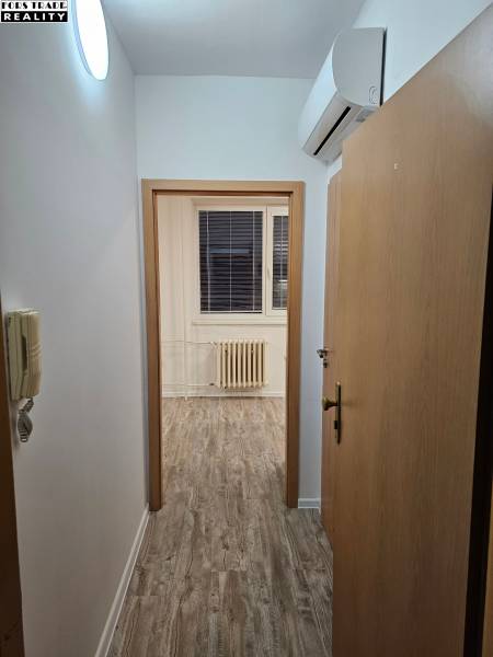 Offices with wood-patterned flooring and air conditioning.