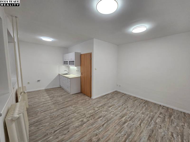 Offices with a kitchenette and flooring with a wood decor.