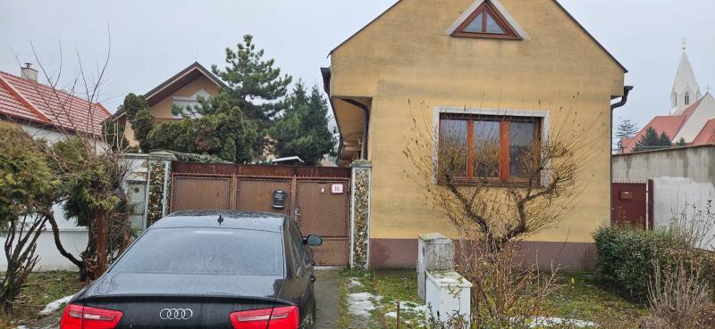 A family house in Bratislava - Podunajské Biskupice, a car parked in front of the gate.