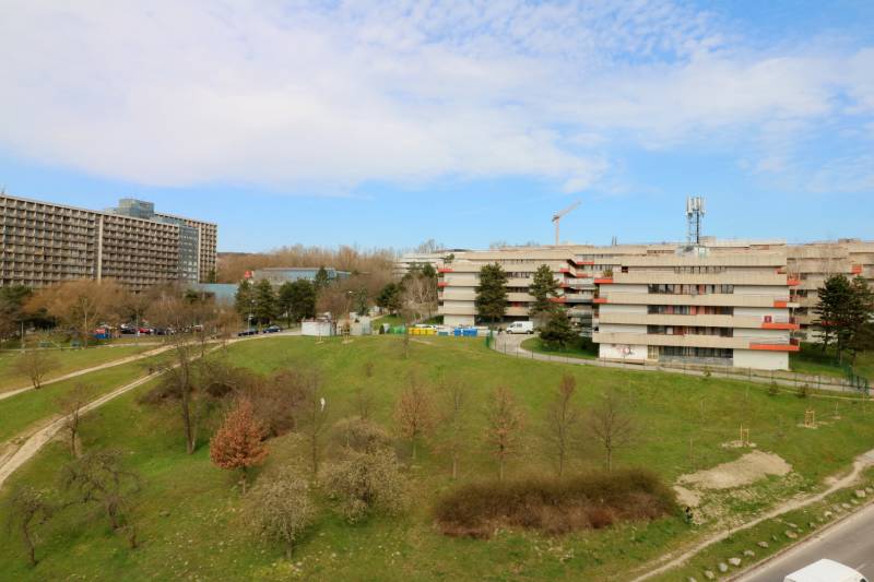 A view of apartment buildings and greenery in Bratislava - Karlova Ves, on Staré Grunty street.