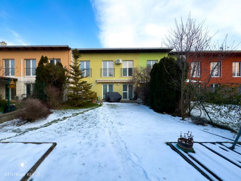A two-story family house on Hrabová Street in Hamuliakovo with a snow-covered garden.