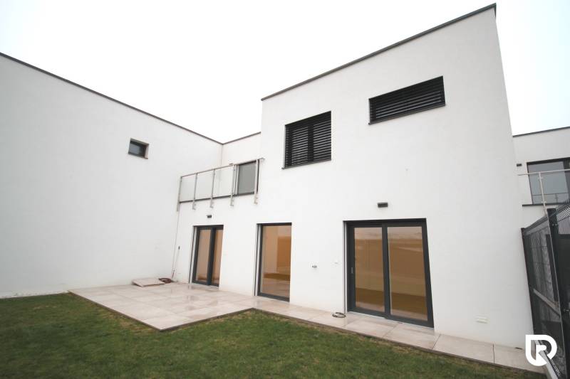 A family house on Legionárska in Trenčín with a terrace and a grassy garden.