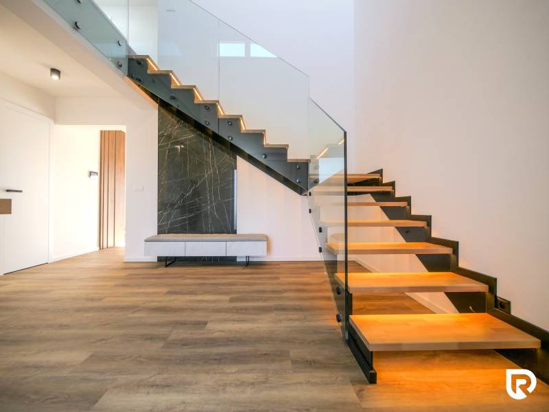 A staircase with glazing and a wooden decor floor in a family house.