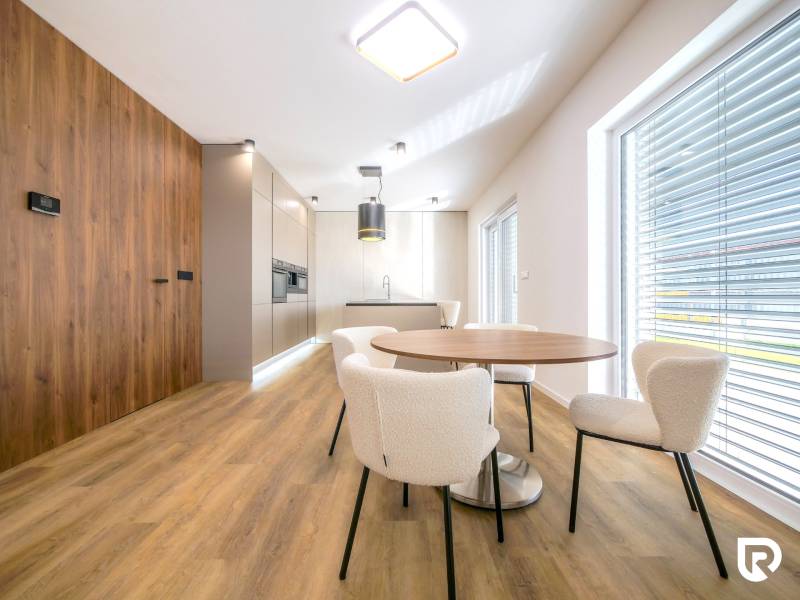 A kitchen with a wooden decor floor and a dining table in a family house.