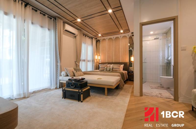 Bedroom in a 3-room apartment with carpet and wood-patterned flooring.