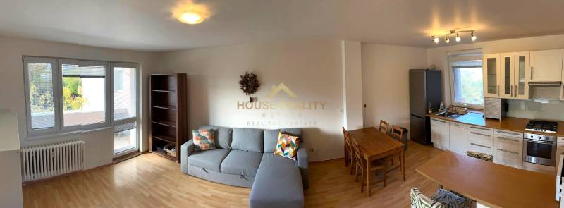 Living room with a kitchen in a 3-room apartment, wooden decor flooring, corner sofa.