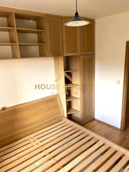 A bedroom in a 3-room apartment with wooden furniture and a floor with a wooden decor.