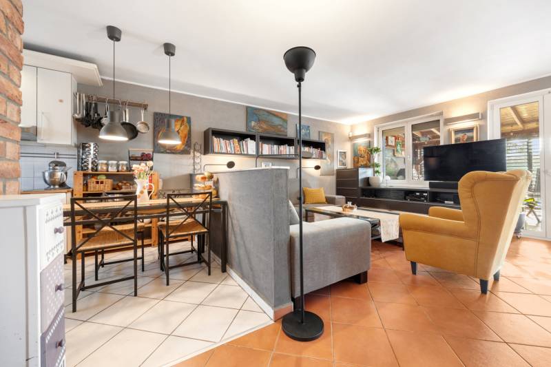 A living room in a family house with a combination of a grey sofa and a yellow armchair.