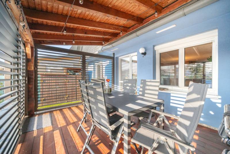 A terrace with a wooden ceiling and floor, dining in a family house on Južná Street, Miloslavov.
