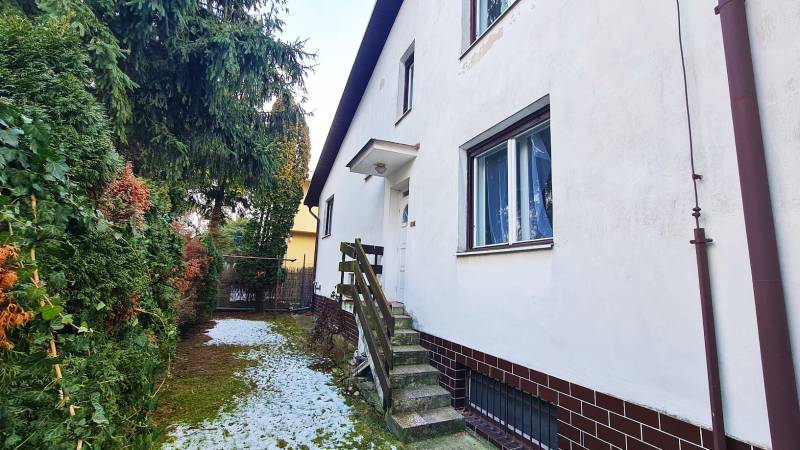 A family house on Fibichova Street in Bratislava - Ružinov with a landscaped garden and snow.