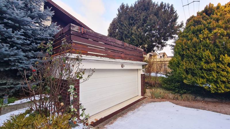 A garage at a family house on Fibichova Street in Bratislava - Ružinov surrounded by greenery in winter.