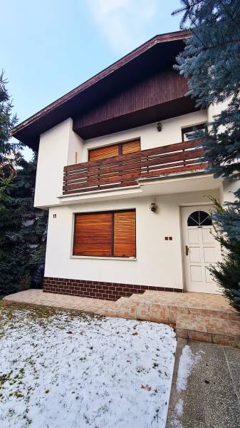 A family house on Fibichova Street in Bratislava - Ružinov with a wooden facade cladding.