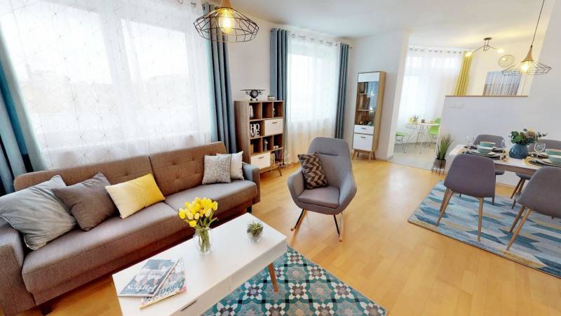 2-room apartment with wood-patterned flooring, bright living area with dining space.