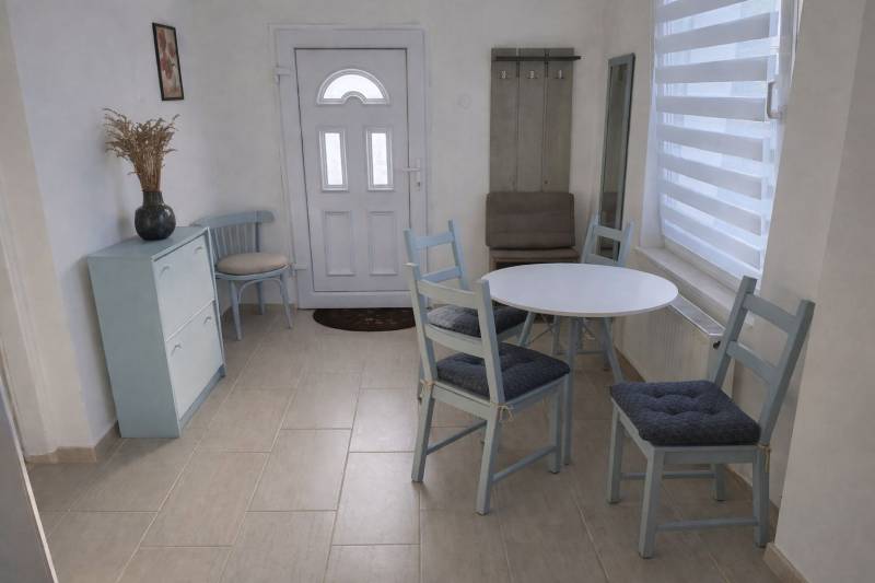 A hallway in a family house with stylish seating and furniture in pastel colors.