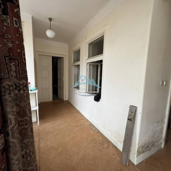Interior of a family house with a wooden decor floor and white walls.