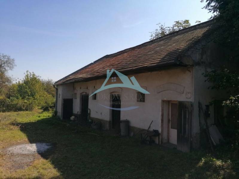 A family house on SNP Street in Šahy with a grassy plot and a sloped roof.