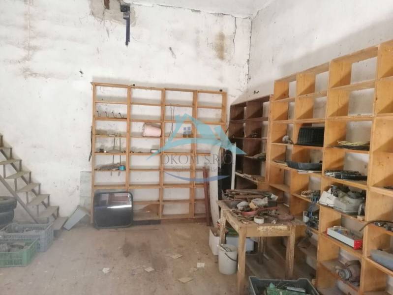 Tool shelf in the interior of a family house, items stored on wooden shelves.