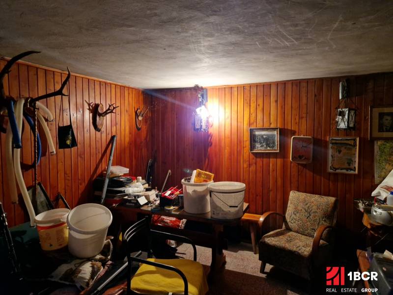 Rustic room with hanging trophies and a wooden decor floor in a family house.