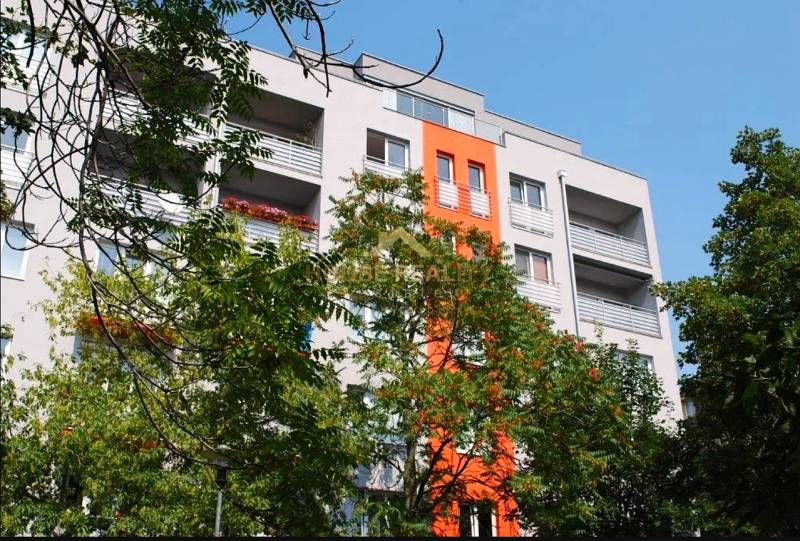 The building on Ovručská Street in Bratislava - Nové Mesto with balconies and greenery in the surroundings.
