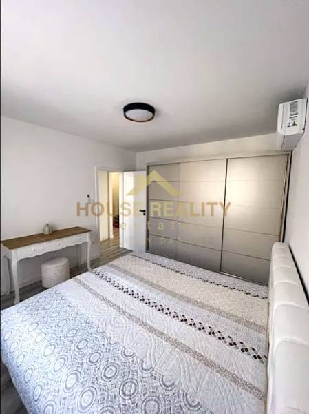 Bedroom with a double bed and a wardrobe, 3-room apartment, floor with wooden decor.