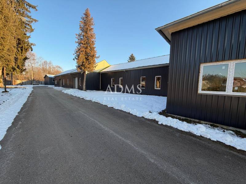 The area of warehouses and halls on Pšurnovická Street in Bytča with a snow-covered road.