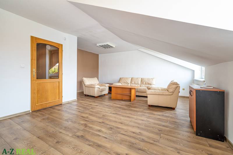 Living room in a family house with solid wood furniture and a floor with a wooden decor.