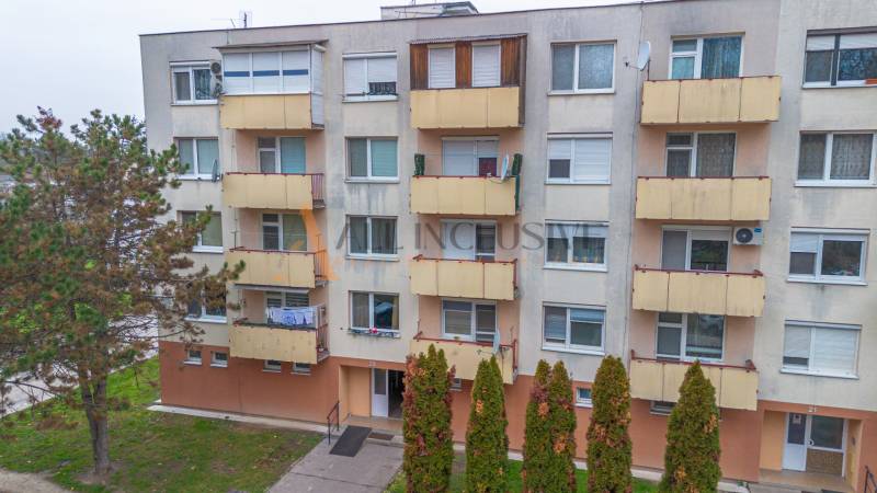Apartment building on Školská Street in Kolárovo with multiple balconies and an entrance portal.