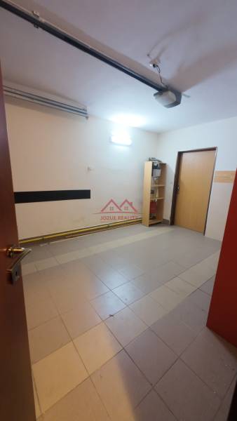 Interior of a family house with tiles and a shelf, neutral walls.
