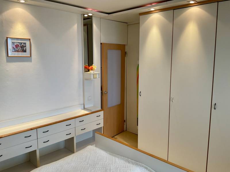 Bedroom in a 3-room apartment with white wardrobes and built-in lighting.