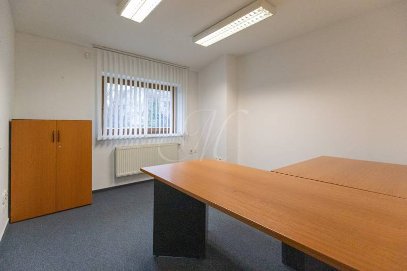 Office in a 4-room apartment with a wooden table and wardrobe, bright interior.