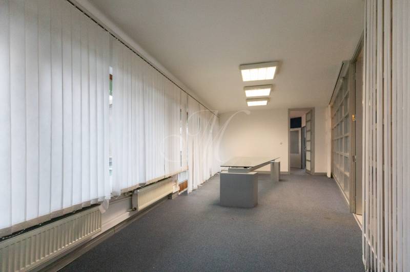 Interior with an office desk, light flooring, and vertical blinds in a 4-room apartment.