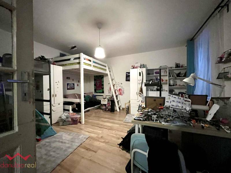 A space in a family house with a bunk bed and a wooden decor floor.